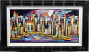 A Harbour Full of Dreams by Rozanne Bell — colourful harbour towers with crooked rooftops and three boats on violet-blue water beneath a bright full moon and sweeping pink, purple and turquoise skies, presented in a black frame