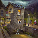A whimsical painted village scene at dusk showing a stone cottage with glowing windows, a small bridge over a stream, street lamps, and several black cats in and around the buildings. This appears to be the artwork itself rather than a photo of a physical product in a room.