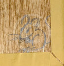 A close-up of a light brown wood grain surface with a gray pencil sketch of a mouse, bordered by a gold-colored frame or mat.