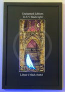 Framed artwork with a ghostly figure in front of a gothic arch, glowing under UV light.