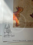 A printed sheet featuring a hand-drawn sketch of two figures hugging with the caption 'LOST IN MUSIC' and 'Smith' signed below, alongside a textured artwork panel showing an orange cat on a beige background. Text at the bottom reads 'Dancing in Our Slippers by Sam Toft' with copyright information.