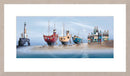 Colorful boats and lighthouse on a beach with a clear sky