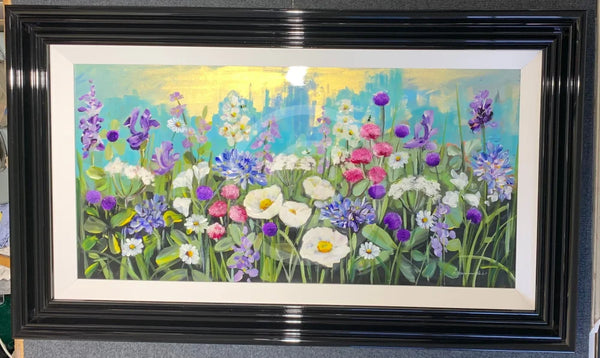 Framed artwork of a colorful floral scene with a black frame.