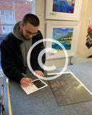 Artist Joe Gill signing his certificates of authenticity