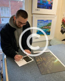 Artist Joe Gill signing his certificates of authenticity