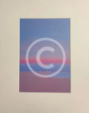 A red sunrise over a pink and blue seascape