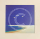 Three white clouds in a blue sky with a beach below.