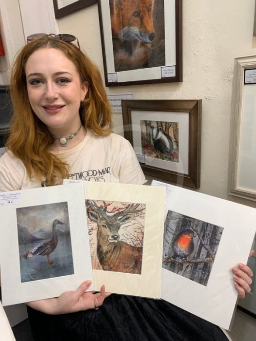 Artist Daisy with a selection of her artwork