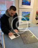 Artist Joe Gill signing his certificates of authenticity