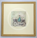 Meet the Mustards: All Aboard the Ducky Express by Sam Toft, mounted miniature print. A fun pictures of a man on a bicycle with two baskets carrying several white ducks and his black and white dog. Framed in oak.
