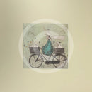Meet the Mustards: All Aboard the Ducky Express by Sam Toft, mounted miniature print. A fun pictures of a man on a bicycle with two baskets carrying several white ducks and his black and white dog. 