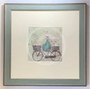 Meet the Mustards: All Aboard the Ducky Express by Sam Toft, mounted miniature print. A fun pictures of a man on a bicycle with two baskets carrying several white ducks and his black and white dog. Framed in Nordic Blue.