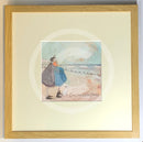 Meet the Mustards: Counting White Horses by Sam Toft, mounted miniature print. A couple on a beach with a black and white dog embracing, and looking up a the clouds. Framed in oak.