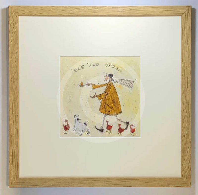 Meet the Mustards: Egg and Spoon by Sam Toft, mounted miniature print. A fun picture of a man having an egg and spoon race whilst four hens nervously keep watch with a black a white dog keeping a watchful eye too. Framed in oak.