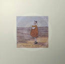 Meet the Mustards: The Importance of Small Things by Sam Toft, mounted miniature print. A thoughtful picture of a man called Mr Mustard stood on the beach looking out sea whilst holding on to his black and white dog Doris. 