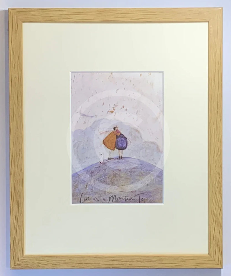 Meet the Mustards: Love On A Mountain Top by Sam Toft, mounted miniature. A couple having a cuddle with their dog on top of a mountain. Framed in oak.