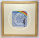 Meet the Mustards: Never Forgotten by Sam Toft, mounted miniature print. A man holding his dog thoughtfully looks up to a beautiful rainbow. Framed in oak.