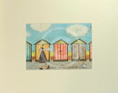 Meet the Mustards: Our Daily Mooch by Sam Toft, mounted miniature. A man walks his dog in front of a colourful row of beach huts.