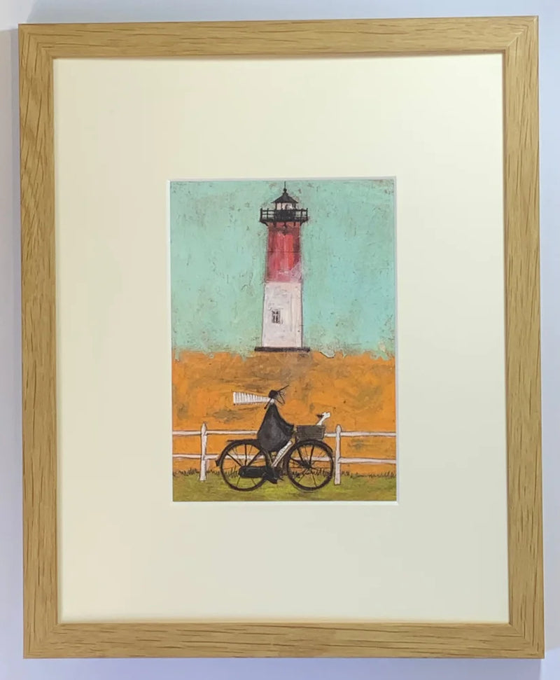 Meet the Mustards: Riding by the Light by Sam Toft, mounted miniature. A man riding a bike, dog in his basket past a light house. Framed in oak.