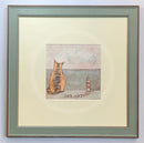 Meet the Mustards: Sea Cat by Sam Toft, mounted miniature print. A ginger cat sitting looking out to sea next to a miniature light house. Framed in Nordic Blue. 