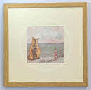 Meet the Mustards: Sea Cat by Sam Toft, mounted miniature print. A ginger cat sitting looking out to sea next to a miniature light house. Framed in oak.