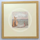 Meet the Mustards: Sea Cat by Sam Toft, mounted miniature print. A ginger cat sitting looking out to sea next to a miniature light house. Framed in oak.