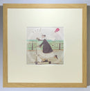 Meet the Mustards: Yay! by Sam Toft, mounted miniature print. A fun picture of a man, Mr Mustard holding a red balloon, rebelliously riding his scooter along the promenade, with his black and white dog Doris on board.  Framed in oak.