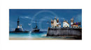 Coastal scene with lighthouse, sailboat, and houses at night.