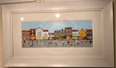 Framed artwork of a colourful York street scene with buildings and people.