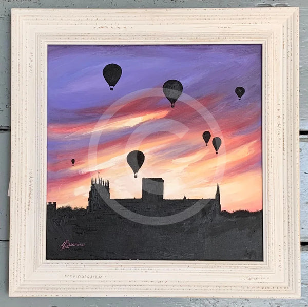 Framed artwork of hot air balloons against a sunset sky with a silhouette of York Minster