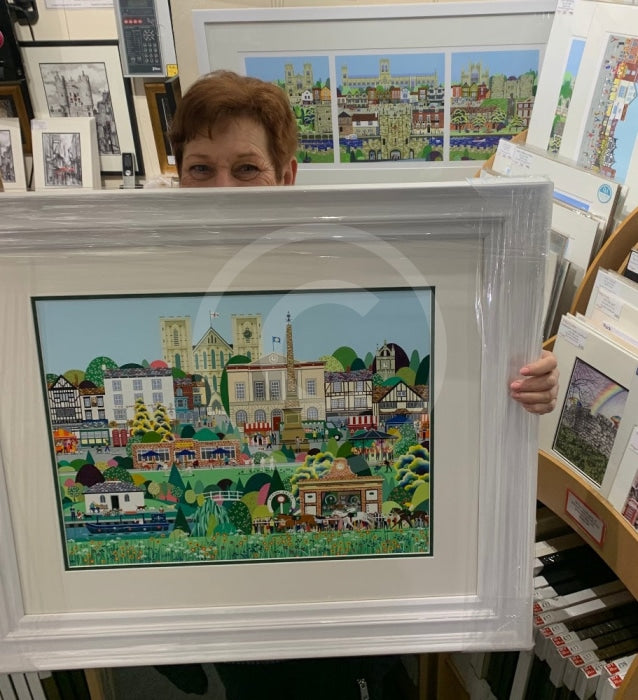Artist Linda Mellin peeping out from behind her Ripon painting