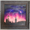 Framed artwork of London city skyline with a purple and pink sky.