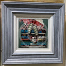 Pretty in Pink by Amanda Stratford Book Cover Art Limited Edition Print.  A girl sits atop a pile of iconic classic childhood books. Framed in a chunky distressed blue frame. 