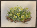 Primroses I by Natalja Olejnicka — miniature mixed media botanical painting of a lush cluster of wild primroses with pale yellow blooms and richly textured leaves, set on golden autumn leaf litter on pale green marbled mountcard