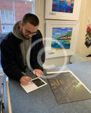 Artist Joe Gill signing his certificates of authenticity