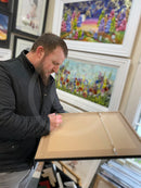 Artist Shaun Tymon signing A Total Shambles original