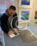 Artist Joe Gill signing his certificates of authenticity