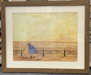 A framed art print featuring a whimsical painting of two figures walking along a pier with a small dog, set in a light brown wood frame with a white mat.