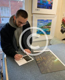Artist Joe Gill signing his certificates of authenticity