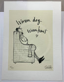 Ernest Hemingway Mustard is relaxing in a deep plaid armchair, with Doris the dog
